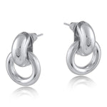 Silver Big Metal London Salema round stud earrings in polished gold or silver-plated recycled metal, hypoallergenic surgical steel posts, 2–3 cm diameter. Sleek, sustainable, everyday chic. Available at Be Charmed