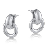 Silver Big Metal London Salema round stud earrings in polished gold or silver-plated recycled metal, hypoallergenic surgical steel posts, 2–3 cm diameter. Sleek, sustainable, everyday chic. Available at Be Charmed