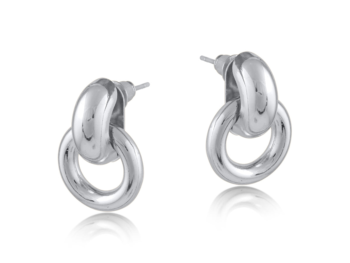 Silver Big Metal London Salema round stud earrings in polished gold or silver-plated recycled metal, hypoallergenic surgical steel posts, 2–3 cm diameter. Sleek, sustainable, everyday chic. Available at Be Charmed