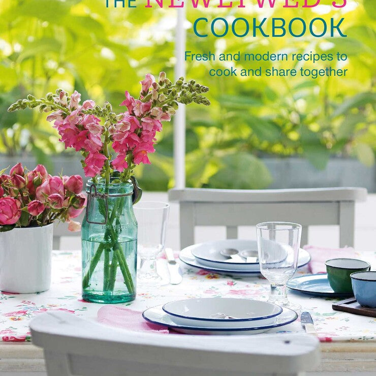 Cookbook cover titled 'The Newlywed's Cookbook' with a table setting and flowers. Available at Be Charmed