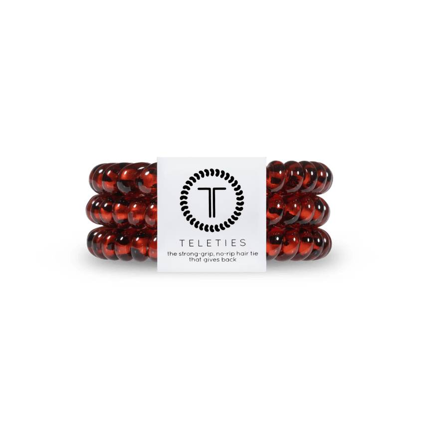 Small Tortoise Teleties Hair Ties—strong grip, waterproof, no crease—available at Be Charmed.