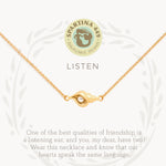 Gold on card Spartina 449 Listen Necklace 18 Inch – Shell charm necklace symbolizing mindfulness and inner peace. Features an engraved “Listen” message and delicate chain. Inspired by the calming sound of the sea. Lightweight, adjustable design with secure clasp.