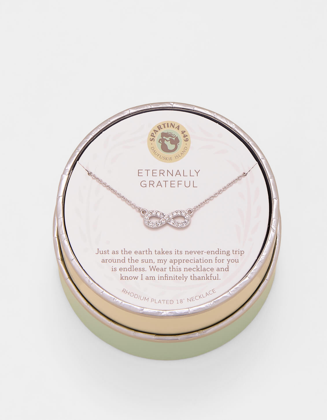 Necklace in a round jewelry box with 'Eternally Grateful' text on a light background. Available at Be Charmed