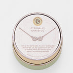 Necklace in a round jewelry box with 'Eternally Grateful' text on a light background. Available at Be Charmed