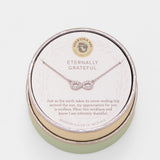 Necklace in a round jewelry box with 'Eternally Grateful' text on a light background. Available at Be Charmed
