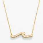 Gold necklace with a wavy design on a white background. Available at Be Charmed