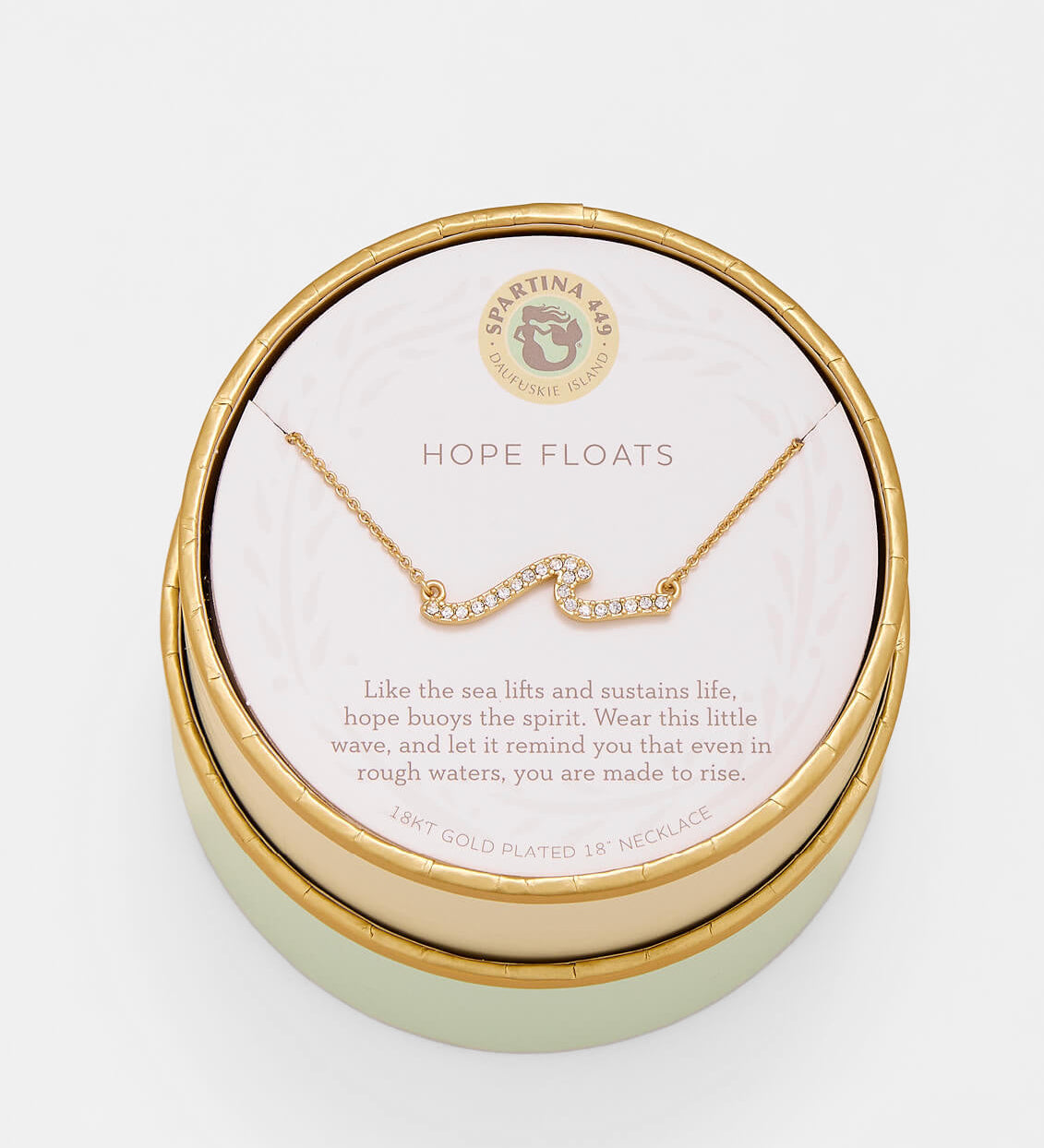 Gold necklace in a round jewelry box with 'Hope Floats' text on a light background. Available at Be Charmed