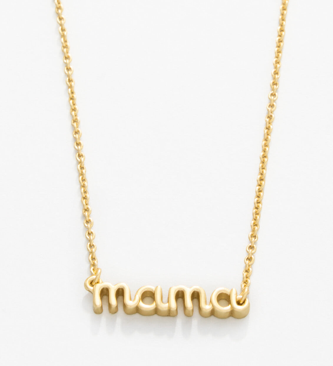 Gold 'mama' necklace on a white background. Available at Be Charmed