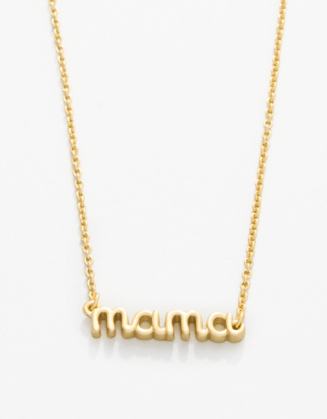 Gold 'mama' necklace on a white background. Available at Be Charmed