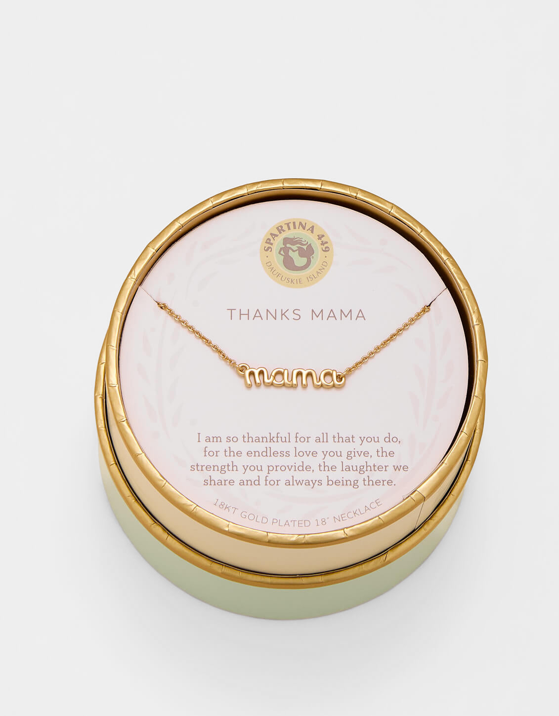 Gold 'mama' necklace in a round box with a message card on a light gray background. Available at Be Chamred