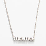 Silver necklace with 'mom' pendant on a white background. Available at Be Charmed