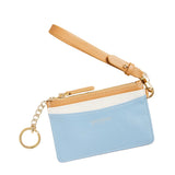 Blue cardholder with beige strap on a beige background. Available at Be Charmed