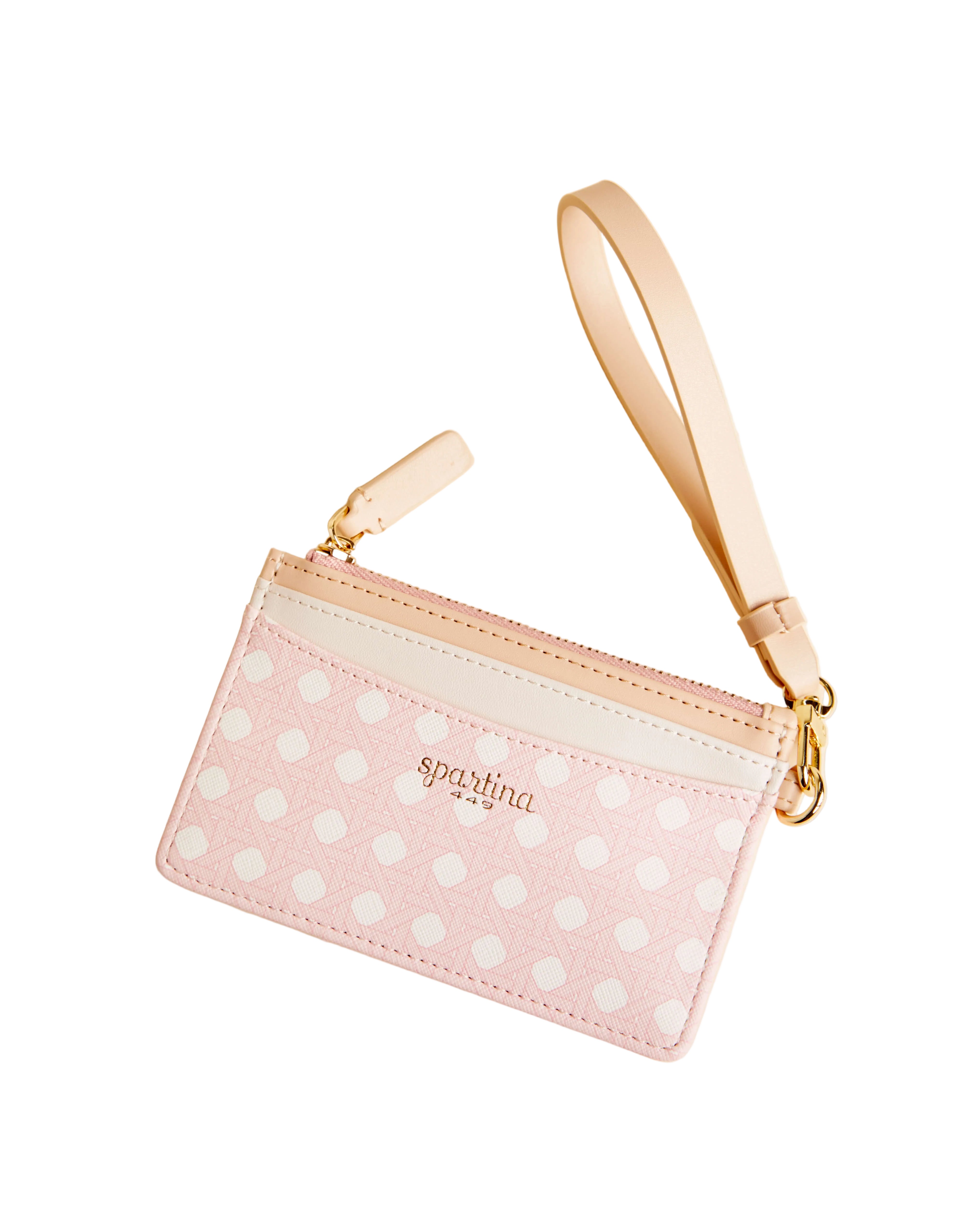 Pink polka dot pouch with gold strap on a beige background. Available at Be Charmed