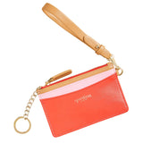Red cardholder with a beige strap and gold chain on a beige background. Available at Be Charmed