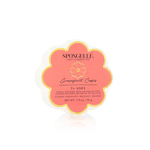 A round Spongellé bar soap with a pink label featuring a flower design and the words 'Cornflower Cassis' along with a net weight of 1.21 lbs. Available at Be Charmed