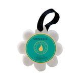 A flower-shaped Spongellé bath sponge with a label that reads 'Wild Flower - Beach Grass' and has a black ribbon loop for hanging. Available at Be Charmed