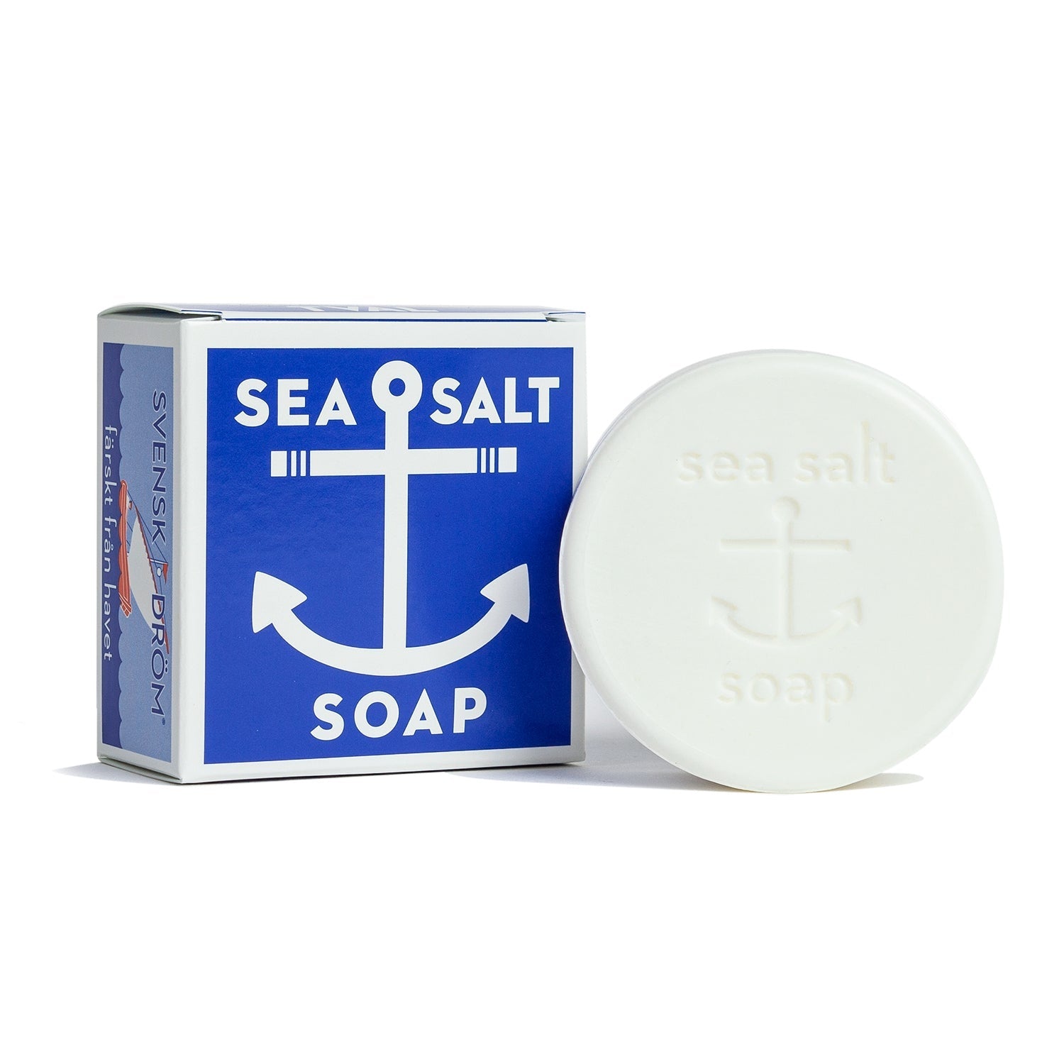 A bar of soap with a blue and white label that reads 'Sea Salt Soap', next to its blue box packaging with a similar design and text. Available at Be Charmed