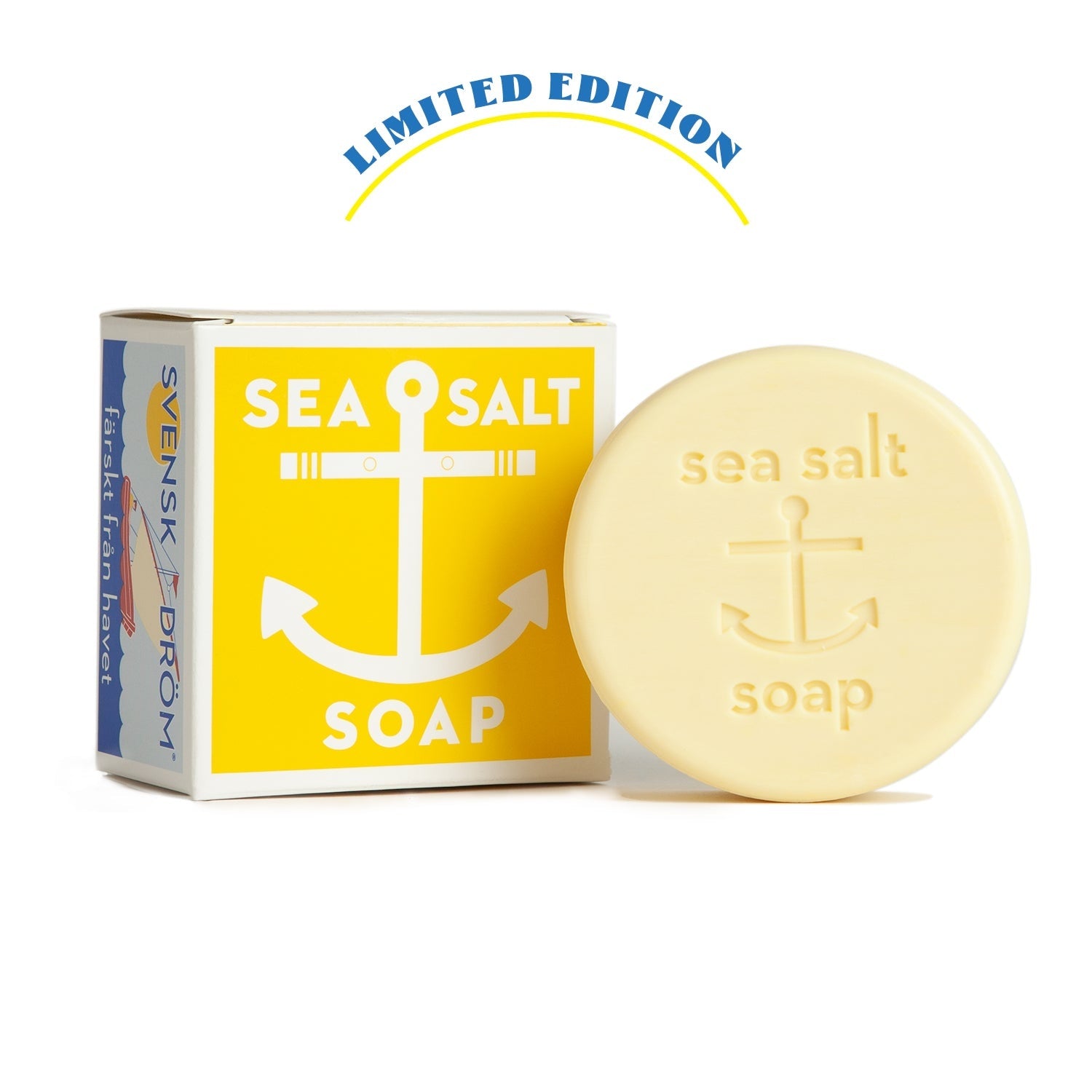 A bar of soap with a yellow label that reads 'Sea Salt' and 'Limited Edition'. The background has a blue and white design with text that reads 'SWEDISH DREAM SOAP'. Available at Be Charmed