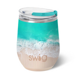 A 12oz Swig brand insulated stemless wine cup with a beach and ocean design. Available at Be Charmed