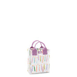 A mini reusable gift bag with a multicolored geometric pattern and purple handles. Available at Be Charmed