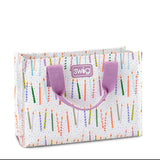 A small reusable gift bag with a multicolored geometric pattern and 'SWIG' branding on the side, featuring purple handles. Available at Be Charmed