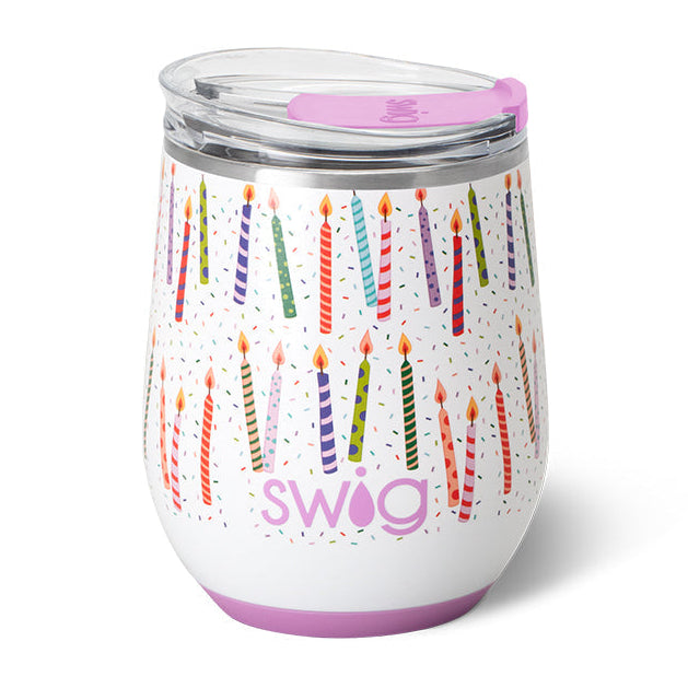A 12oz Swig stemless wine cup with a white background and decorative patterns, including candles. Available at Be Charmed
