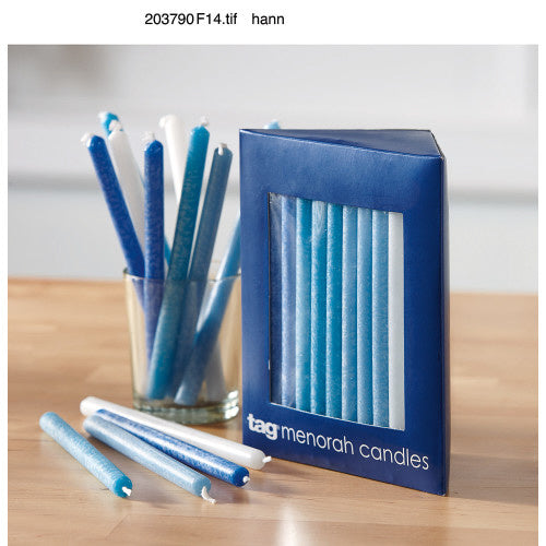 Menorah candles with a blue packaging box on a wooden surface. Availale at Be Charmed