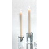 Two lit candles in clear glass candle holders on a white background. Available at Be Charmed
