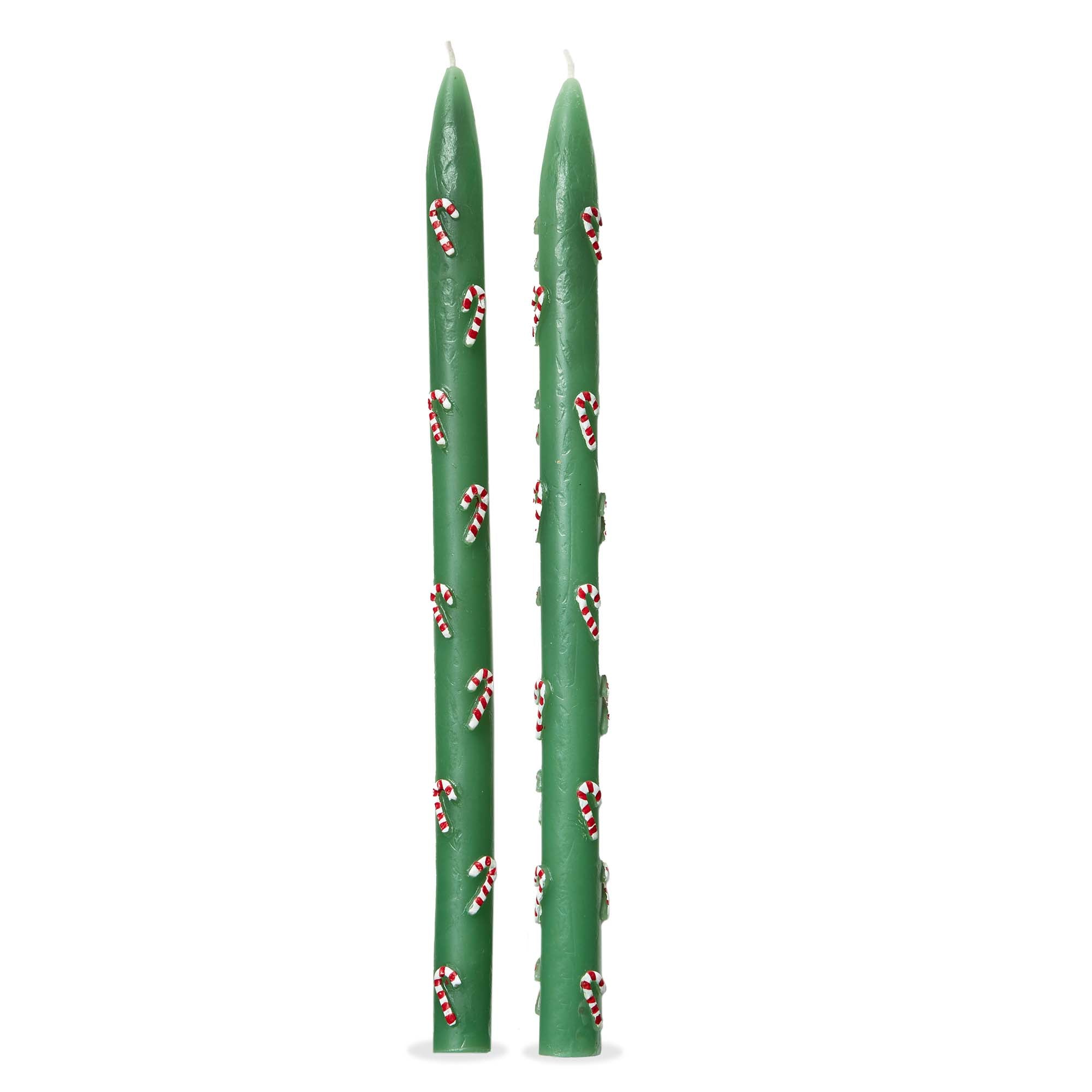 Two green candles with candy cane patterns on a white background.  Available at Be Charmed