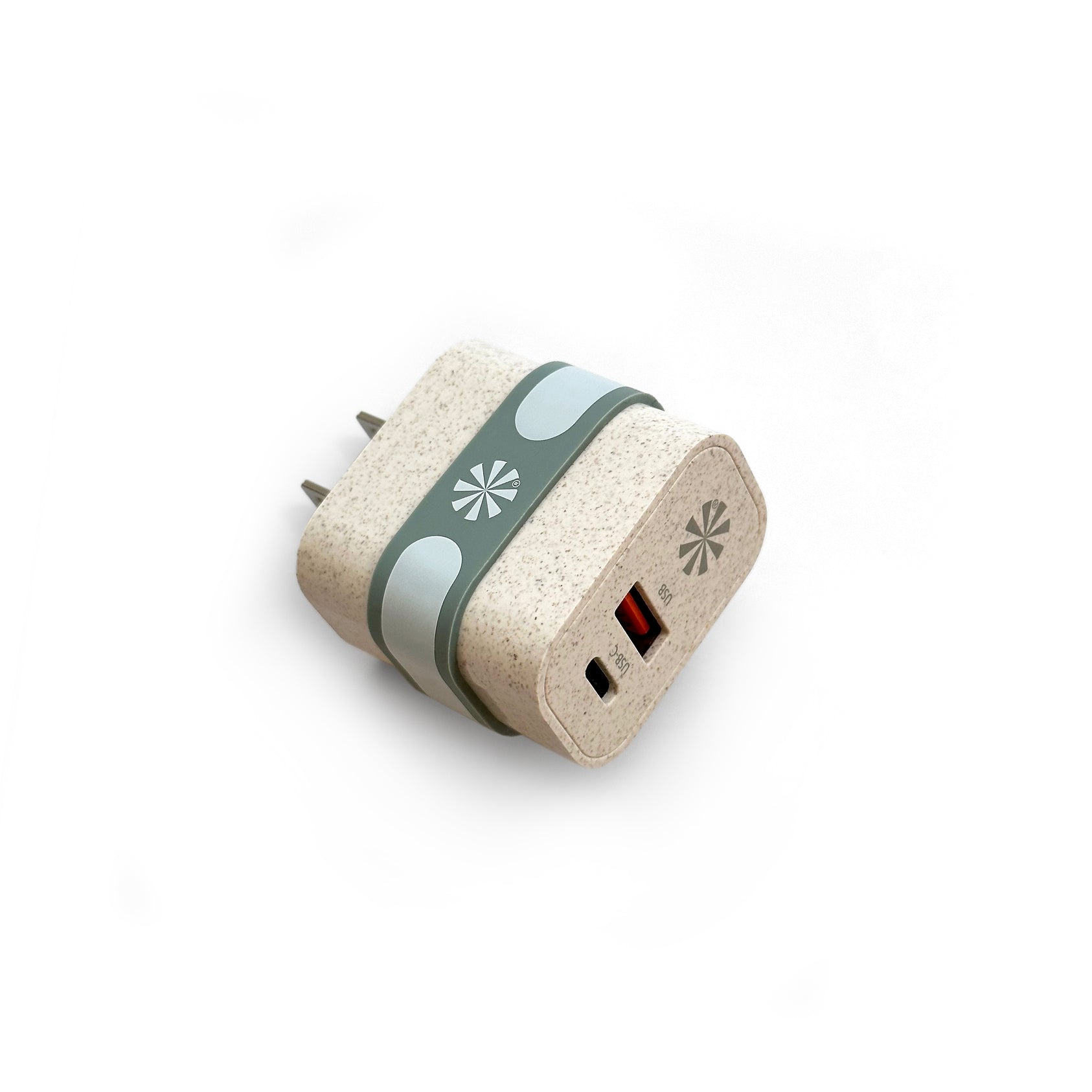 Tech Candy Cork-textured plug adapter with a green band on a white background. Available at Be Charmed