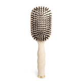 Tan Teleties hairbrush with boar bristle head on a white background. Available at Be Charmed