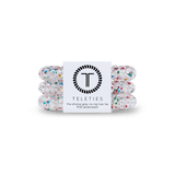 Pack of three Teleties hair ties with a label that reads 'the strong grip, no rip hair tie that doubles as a bracelet. Strong, pretty and stylish. Available at Be Charmed