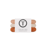 Stack of For the love of nudes hair ties with a Teleties branded card on a white background. Available at Be Charmed