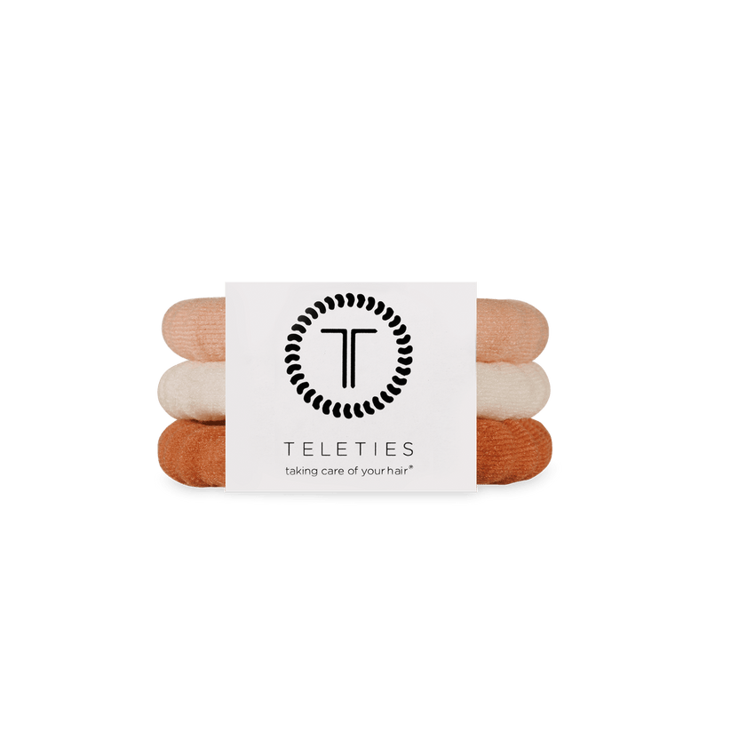 Stack of For the love of nudes hair ties with a Teleties branded card on a white background. Available at Be Charmed