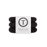 Large Set of jet black hair ties with a Teleties branded card on a white background. Available at Be Charmed
