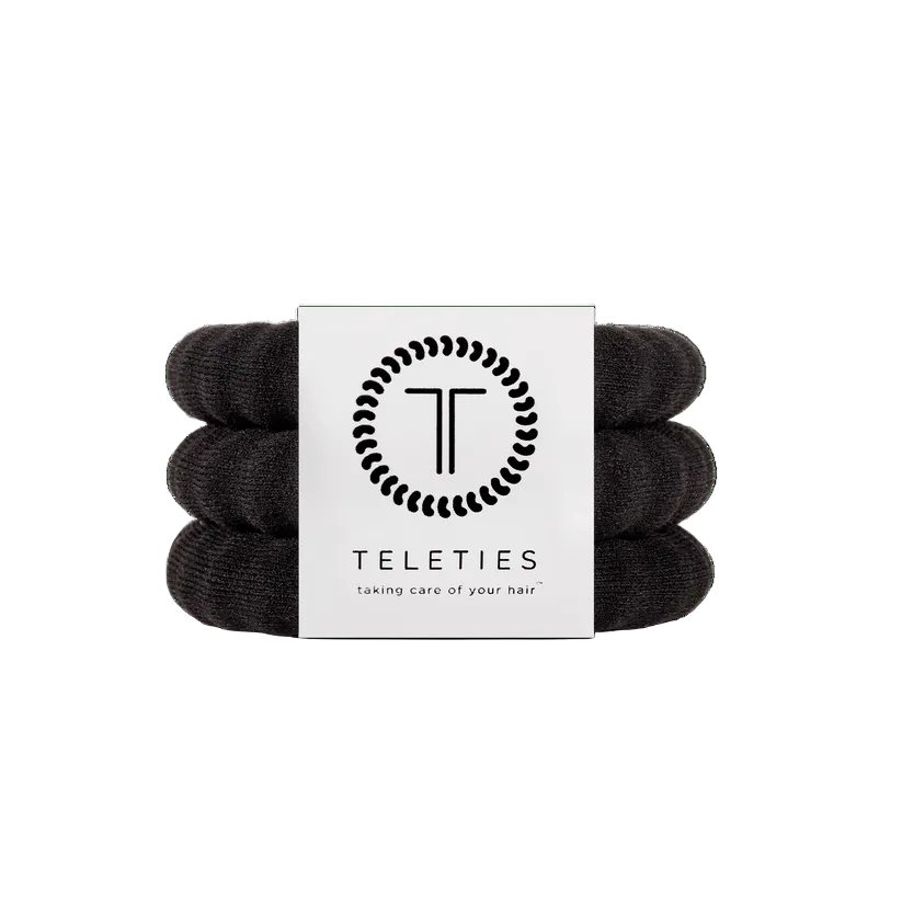 Large Set of jet black hair ties with a Teleties branded card on a white background. Available at Be Charmed