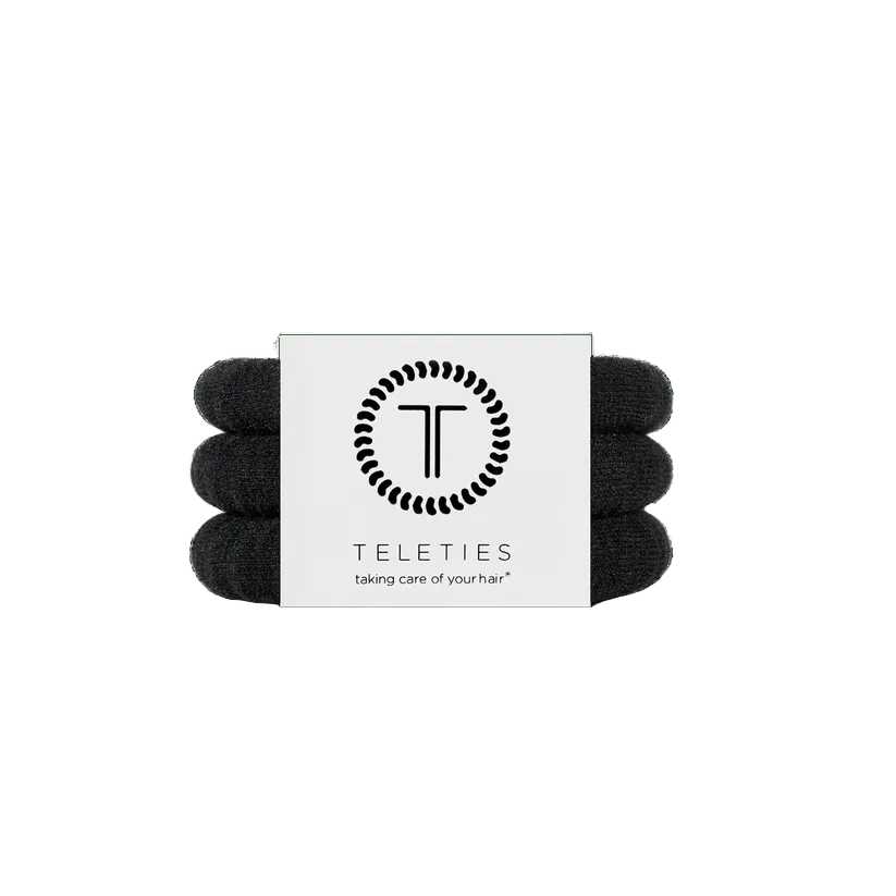 Set of jet black hair ties with a Teleties branded card on a white background. Available at Be Charmed