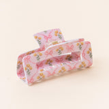 A floral patterned hair claw clip on a light background. Available at Be Charmed