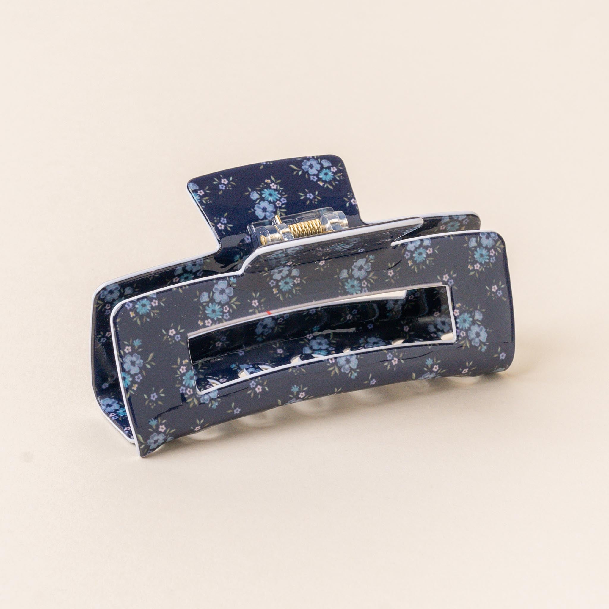 A floral patterned hair claw clip on a light background. Available at Be Charmed
