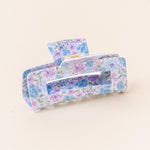 A floral patterned hair claw clip on a light background. Available at Be Charmed