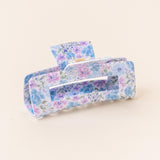 A floral patterned hair claw clip on a light background. Available at Be Charmed