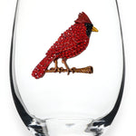 A premium handcrafted stemless wine glass featuring a sparkling jeweled rhinestone cardinal design, available at Be Charmed.