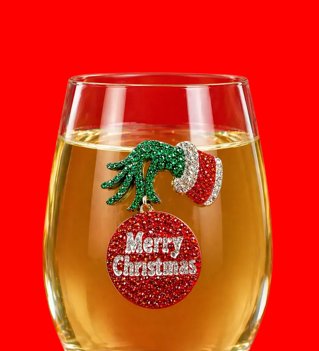 A premium handcrafted stemless wine glass featuring a sparkling jeweled rhinestone grumpy Christmas holiday design, available at Be Charmed.