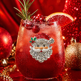 A premium handcrafted stemless wine glass featuring a sparkling jeweled rhinestone Santa Claus design, available at Be Charmed.