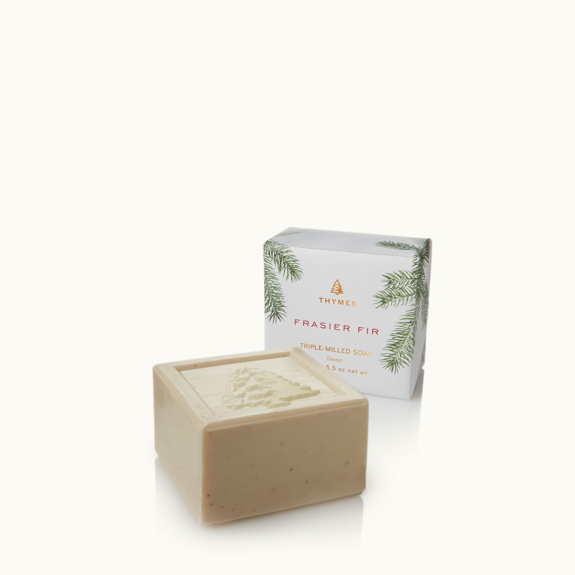 Thymes Frasier Fir bar soap next to its packaging box with a sprig of fir branch design on the box. Available at Be Charmed