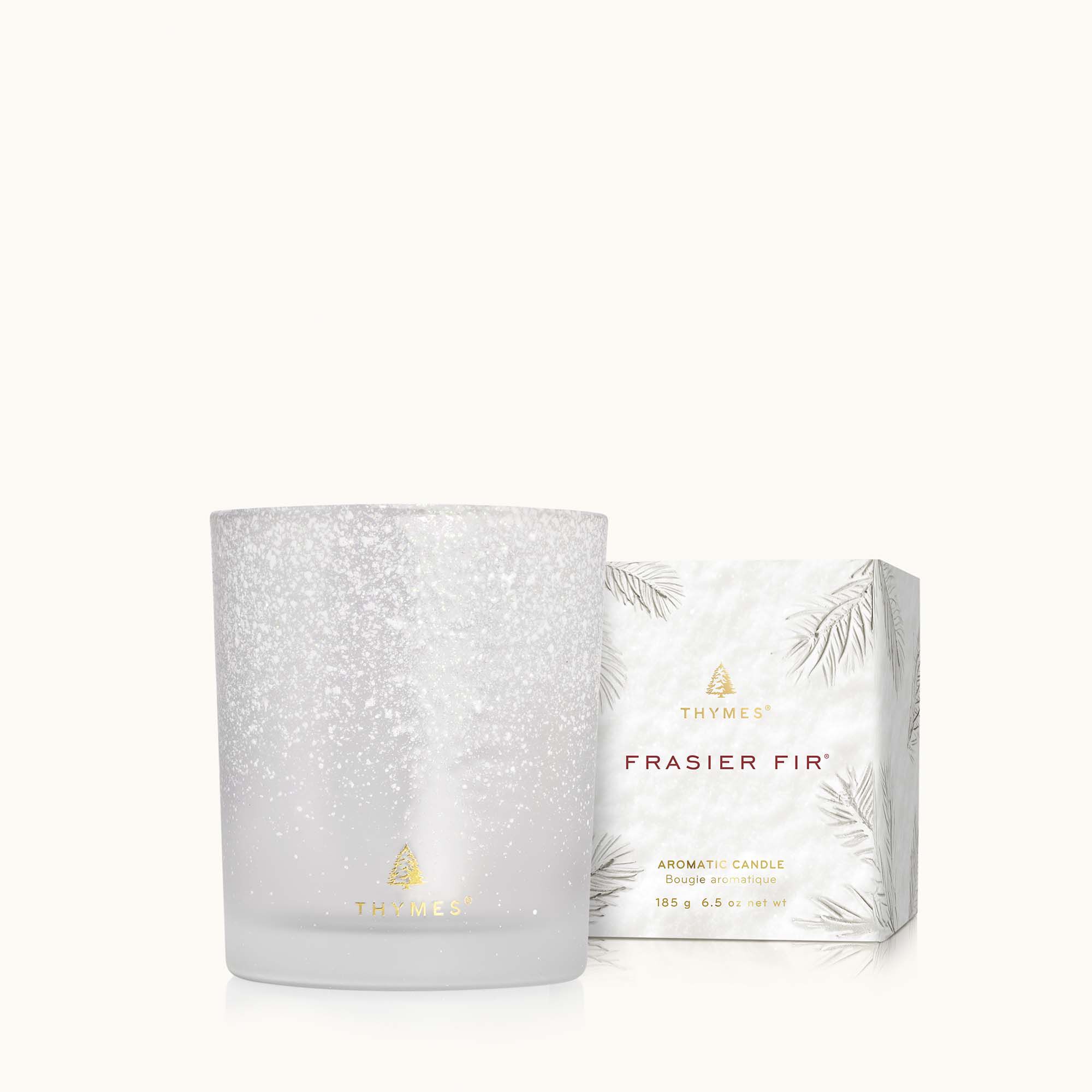 Thymes Frasier Fir Flocked 6.5 oz Poured Candle with festive pine fragrance and decorative flocked design. Available at Be Charmed.