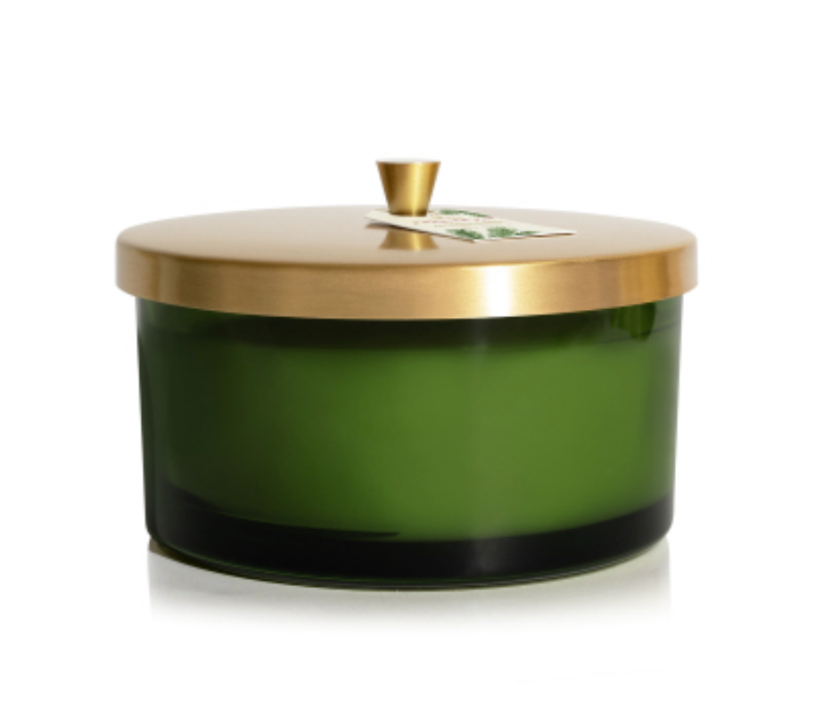 A 21 oz Thymes Frasier Fir green candle with a gold lid and a label that has the brand name and product information. Available at Be Charmed
