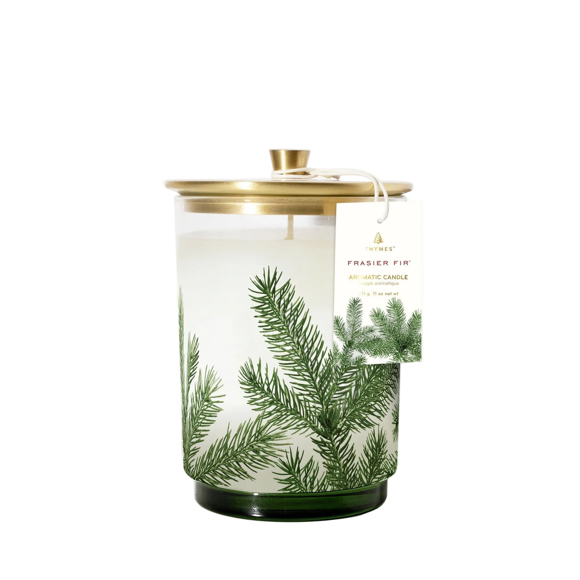 A clear glass candle with a lid and a label that reads 'Thymes Frasier Fir Pine Needle' with a green and white design. Available at Be Charmed