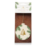 A round Thymes Frasier Fir sachet with a Christmas tree and pine needles design, packaged in a card with the brand name visible. Available at Be Charmed