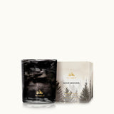 Thymes 6.5oz Noir Woods candle with packaging on a white background. Available at Be Charmed.  